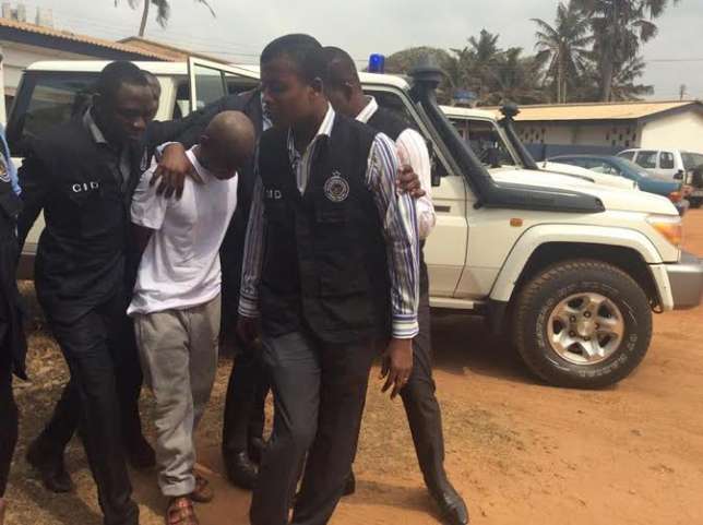 The suspect arrives in court under heavy Police guard