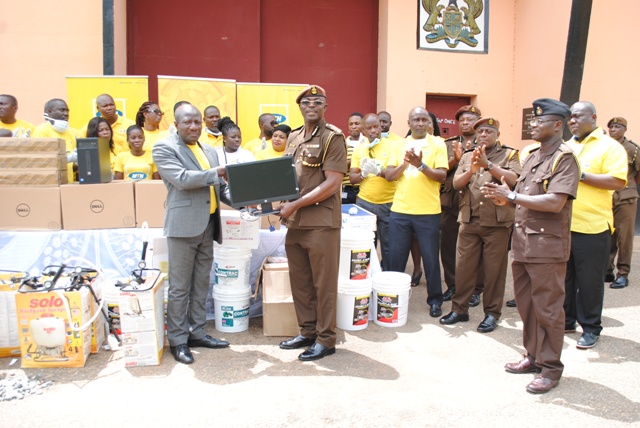 CEO OF MTN GHANA, Mr. Enenezer Asante presenting computers and fumigation equipment to the commander-in-charge of the Nsawam Prison, Isaac Kofi Egyir