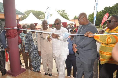 President Mahama cuts sod to commission the new 6-classroom block with Groupe Ideal CEO, Dr. Nii Kotei Dzani looks on