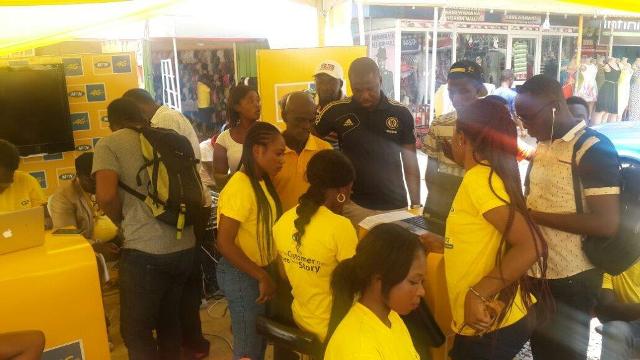 Cross section of customers swapping their SIM cards at an experiential show