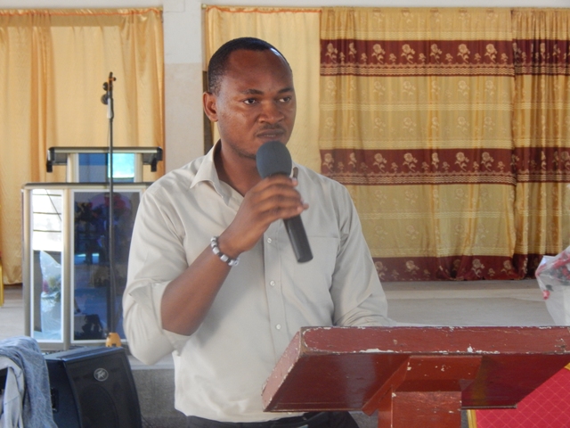Exodus Baduor talks to fellow members of the Sege Youth Development Fund