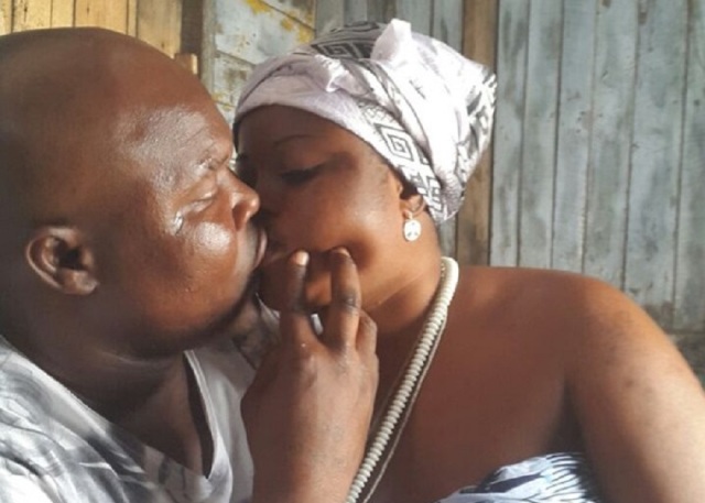 Bukom Banku kissing one of his wives - he's in trouble for assaulting another woman who refused to kiss him