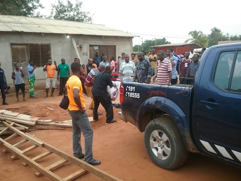 The Kasseh Police carrying the dead body away from the crime scene