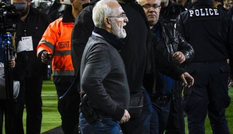 PAOK owner and one of the richest men in Greece Ivan Savvidis runs onto the pitch with a gun visibly strapped to his belt.