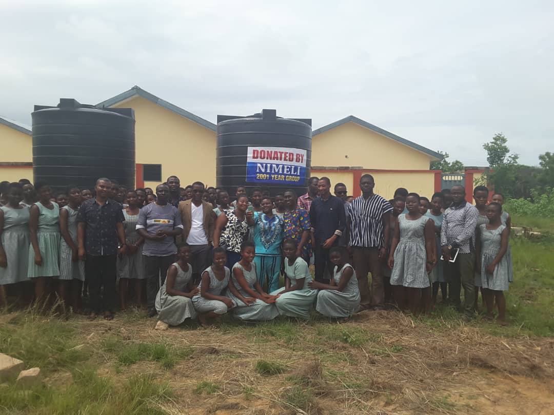 Group photograph of the 2001 year group and current students of Adasco aftre the donation